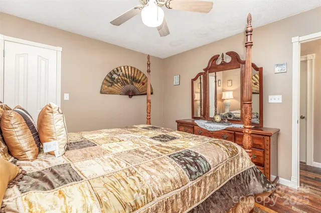 a bedroom with a bed and dresser with mirror