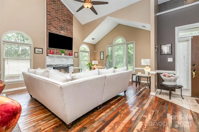 a living room with furniture fireplace and flat screen tv