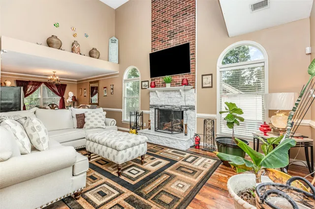 a living room with furniture a fireplace and a flat screen tv