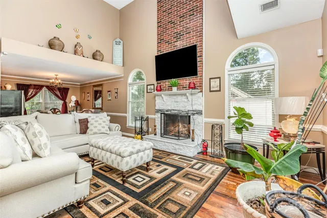 a living room with furniture a fireplace and a flat screen tv