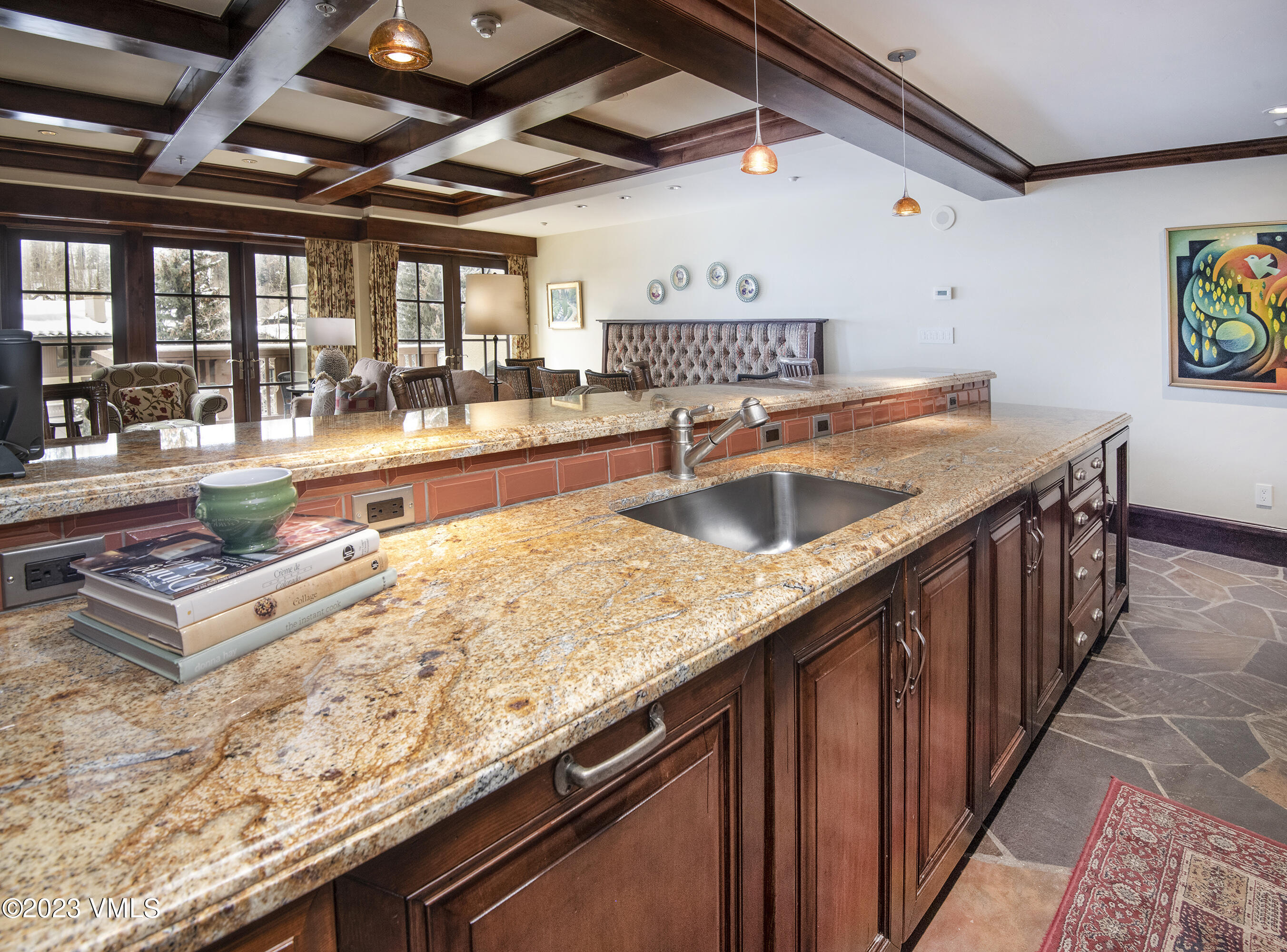 1 Willow Bridge Road, Unit 32F Vail, CO 81657 - Photo 11 of 41 a kitchen with stainless steel appliances granite countertop a sink counter space and wooden floors