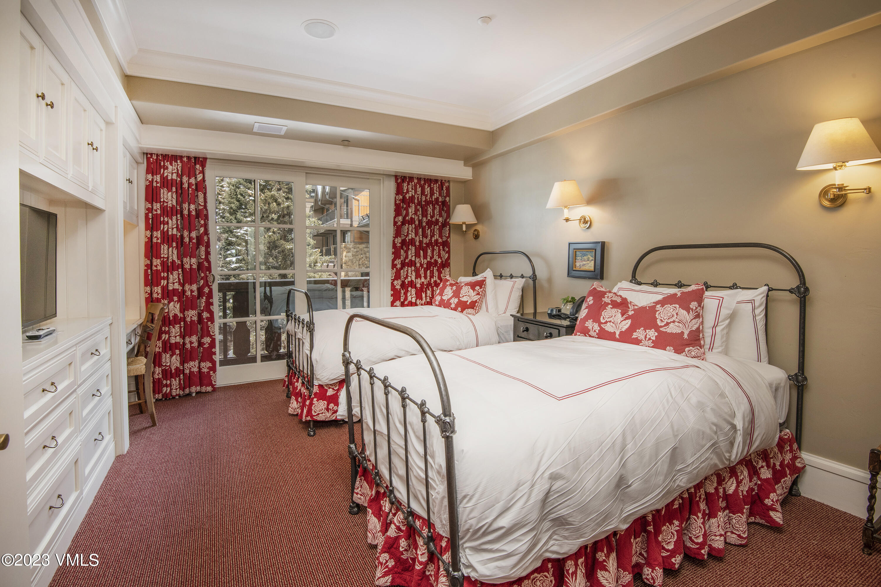 1 Willow Bridge Road, Unit 32F Vail, CO 81657 - Photo 22 of 41 a bedroom with a bed and a flat tv screen on dresser