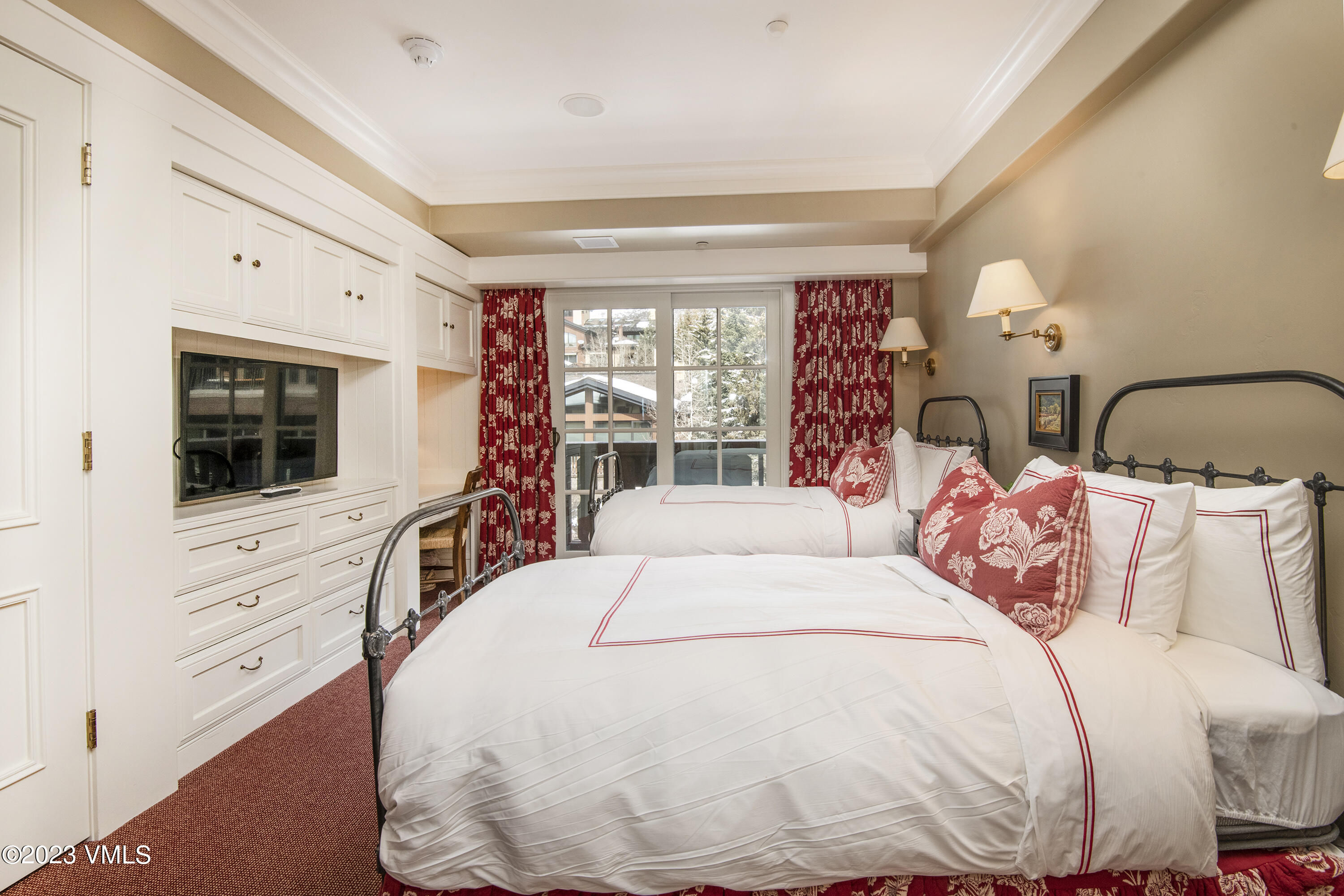 1 Willow Bridge Road, Unit 32F Vail, CO 81657 - Photo 23 of 41 a bedroom with a large bed and a flat tv screen on dresser