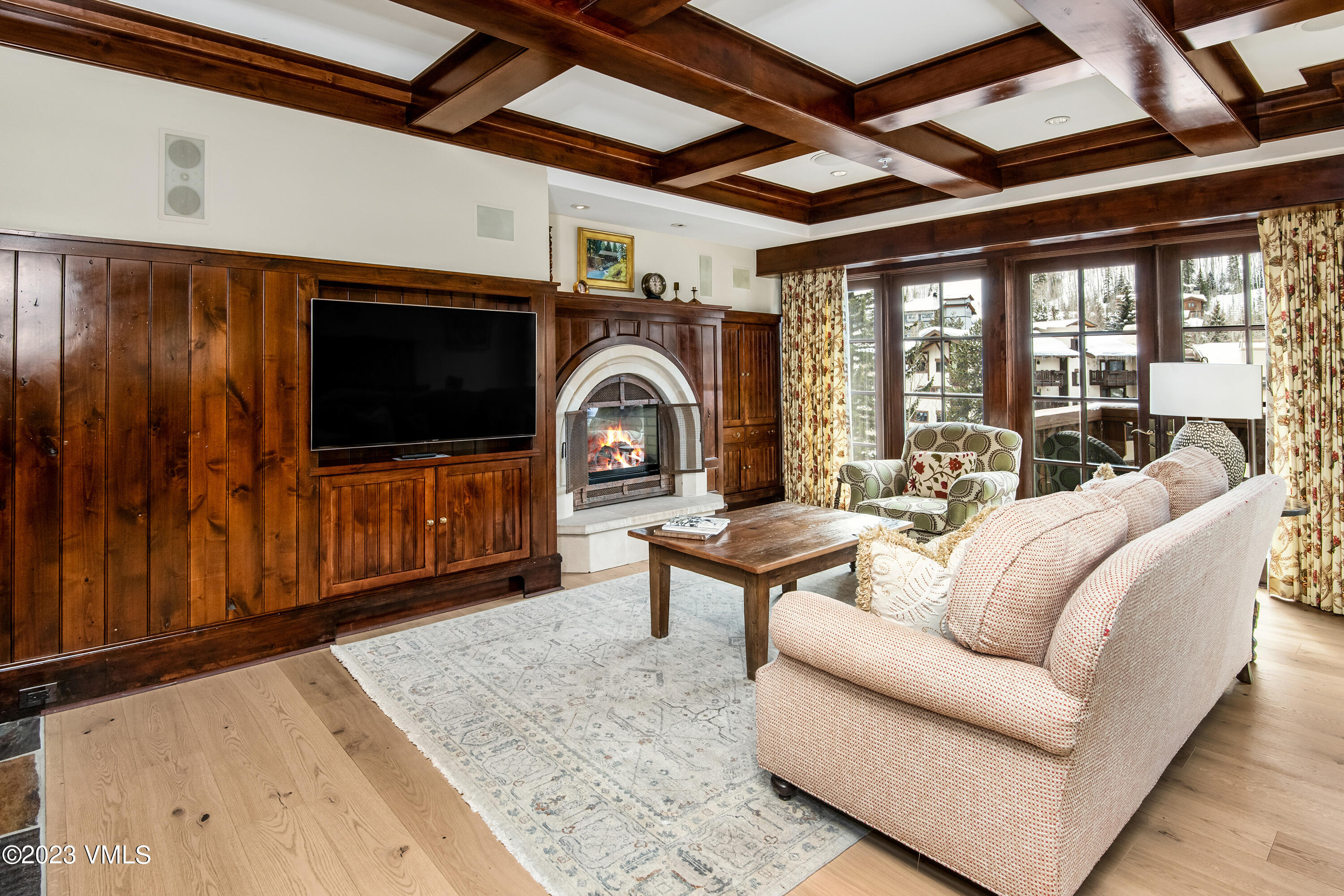 1 Willow Bridge Road, Unit 32F Vail, CO 81657 - Photo 2 of 41 a living room with furniture a flat screen tv and a floor to ceiling window