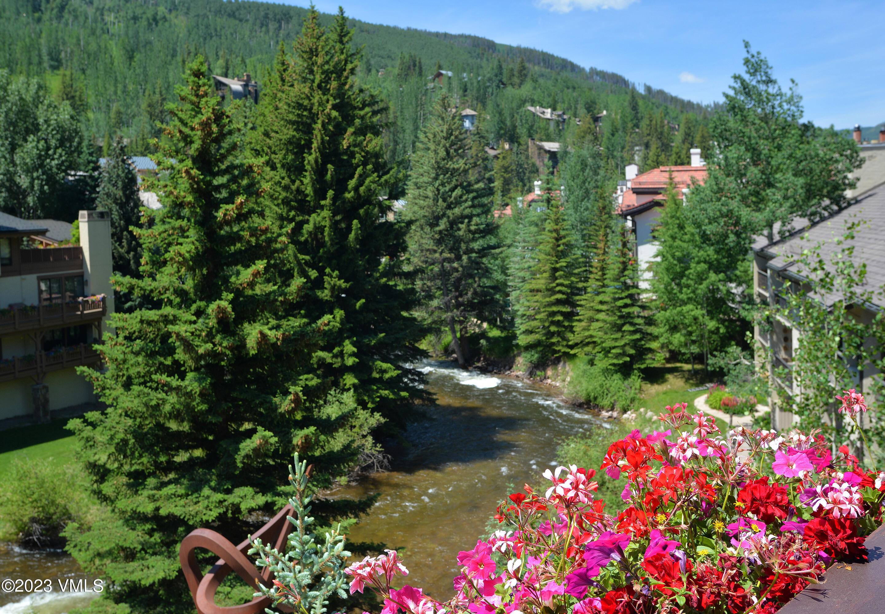 1 Willow Bridge Road, Unit 32F Vail, CO 81657 - Photo 39 of 41 a view of a lake with a house in the background