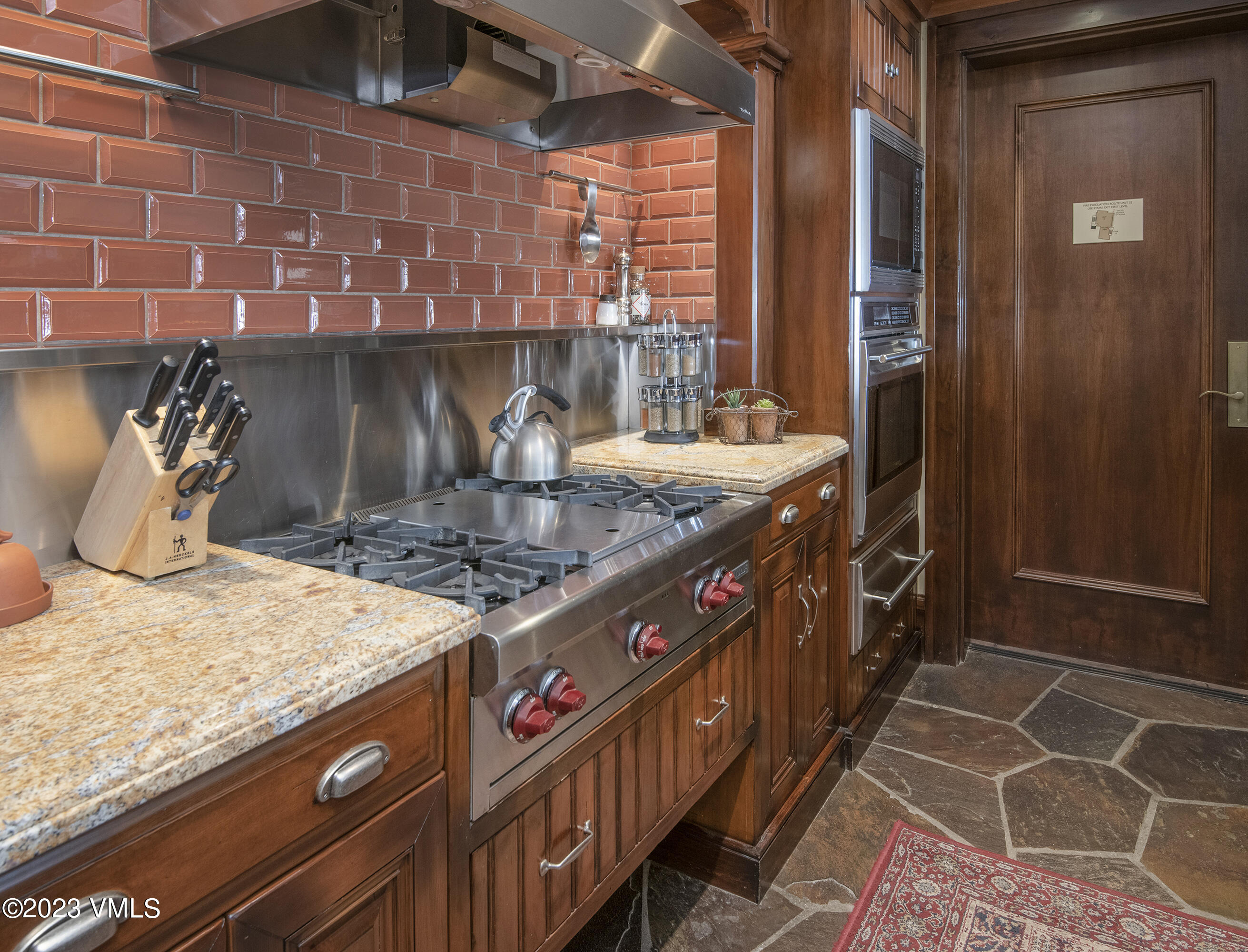 1 Willow Bridge Road, Unit 32F Vail, CO 81657 - Photo 9 of 41 a kitchen with granite countertop a stove and cabinets