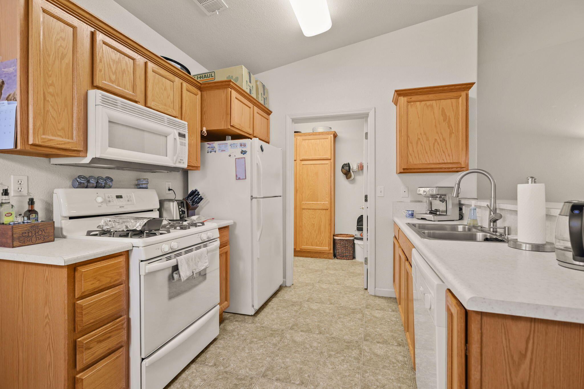 732 Stonebriar Trail Redding, CA 96003 - Photo 7 of 18 a kitchen with stainless steel appliances granite countertop a sink stove refrigerator and cabinets