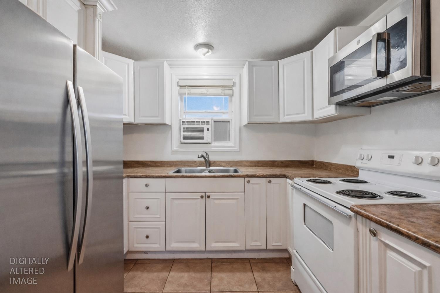 1829 River Road Modesto, CA 95351 - Photo 1 of 44 a kitchen with granite countertop white cabinets and stainless steel appliances