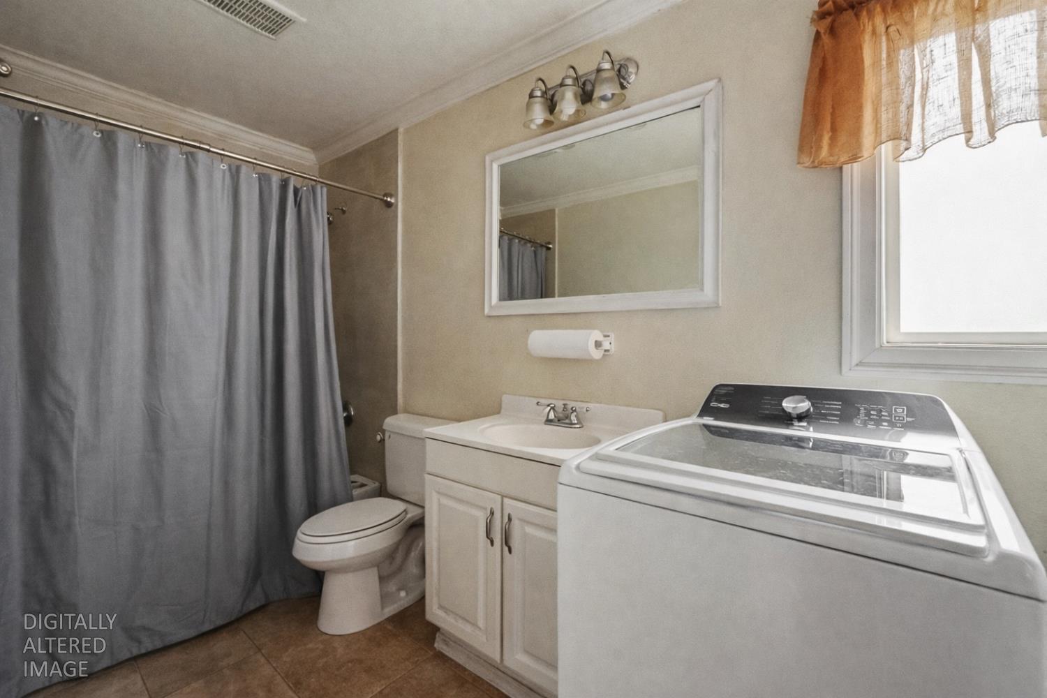 1829 River Road Modesto, CA 95351 - Photo 16 of 44 a bathroom with a sink a toilet and a mirror