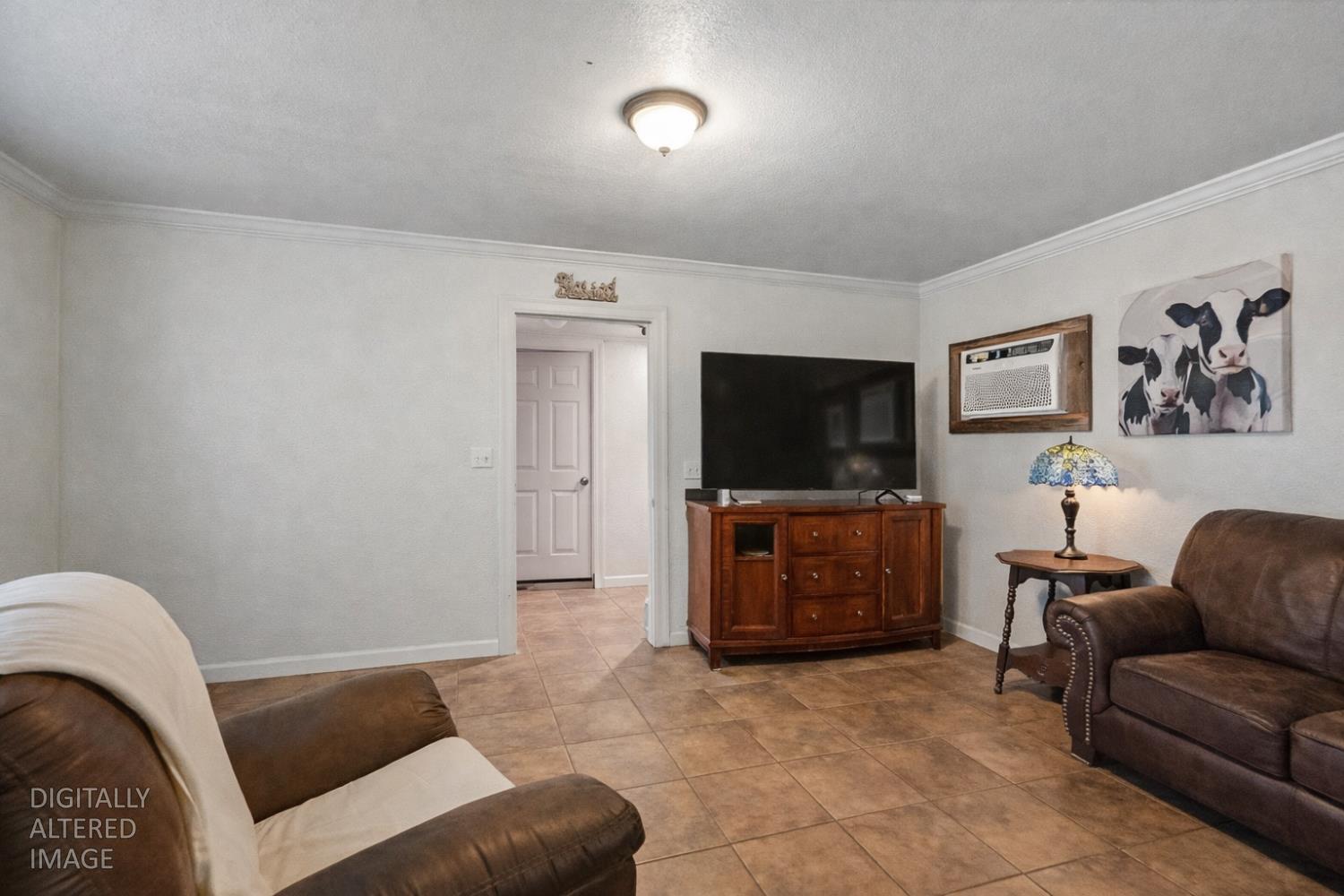 1829 River Road Modesto, CA 95351 - Photo 17 of 44 a living room with furniture and a flat screen tv