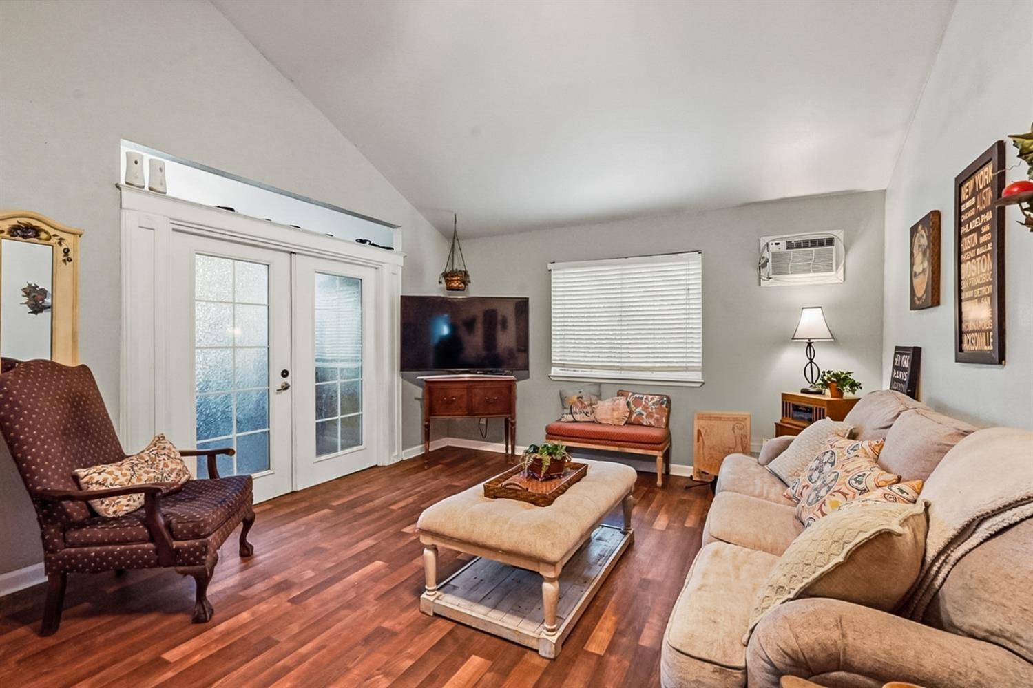 1829 River Road Modesto, CA 95351 - Photo 19 of 44 a living room with furniture a flat screen tv and a window