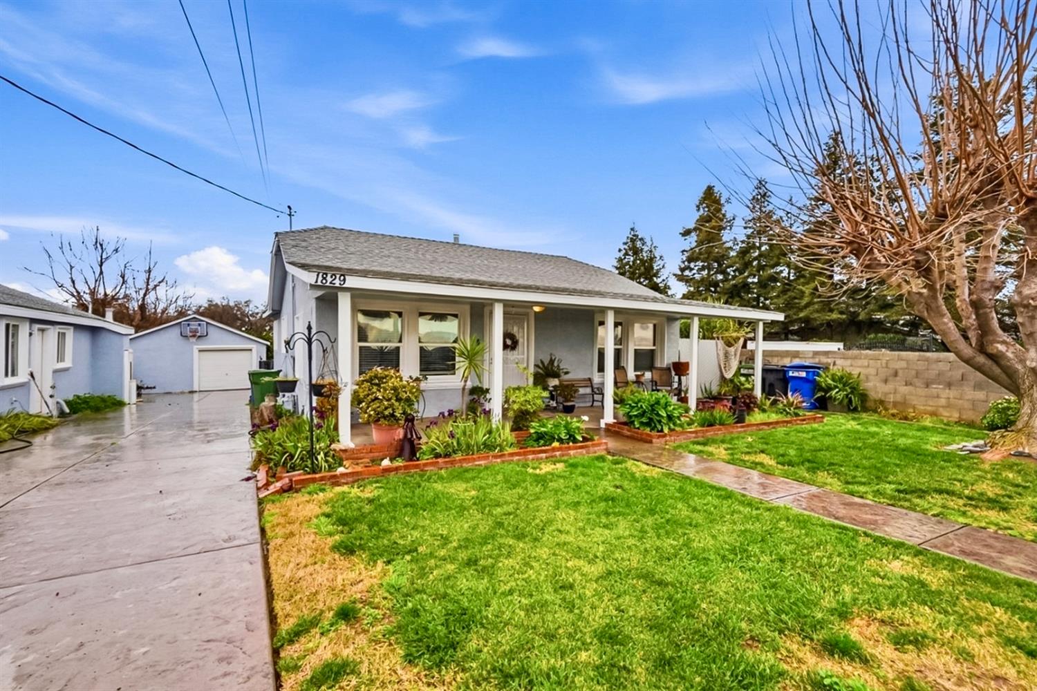 1829 River Road Modesto, CA 95351 - Photo 20 of 44 a front view of a house with a yard table and chairs