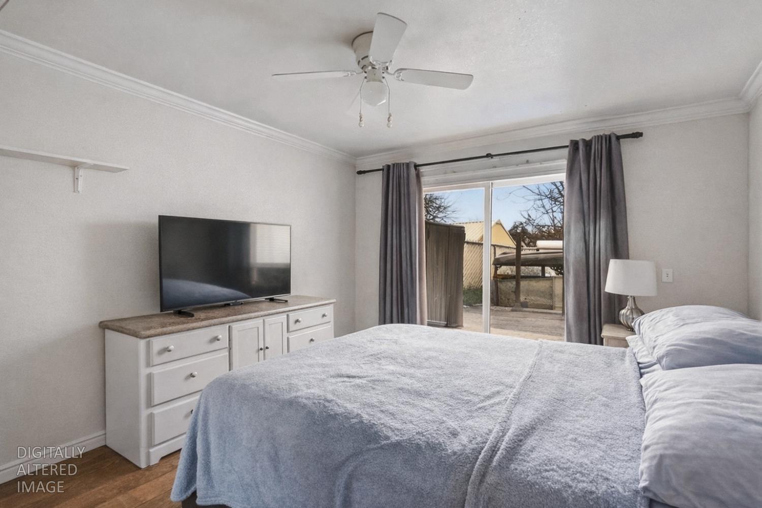 1829 River Road Modesto, CA 95351 - Photo 21 of 44 a bedroom with a bed and a flat screen tv