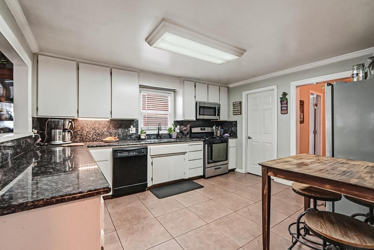 1829 River Road Modesto, CA 95351 - Photo 35 of 44 a kitchen with granite countertop stainless steel appliances a sink a counter top space cabinets and stainless steel appliances