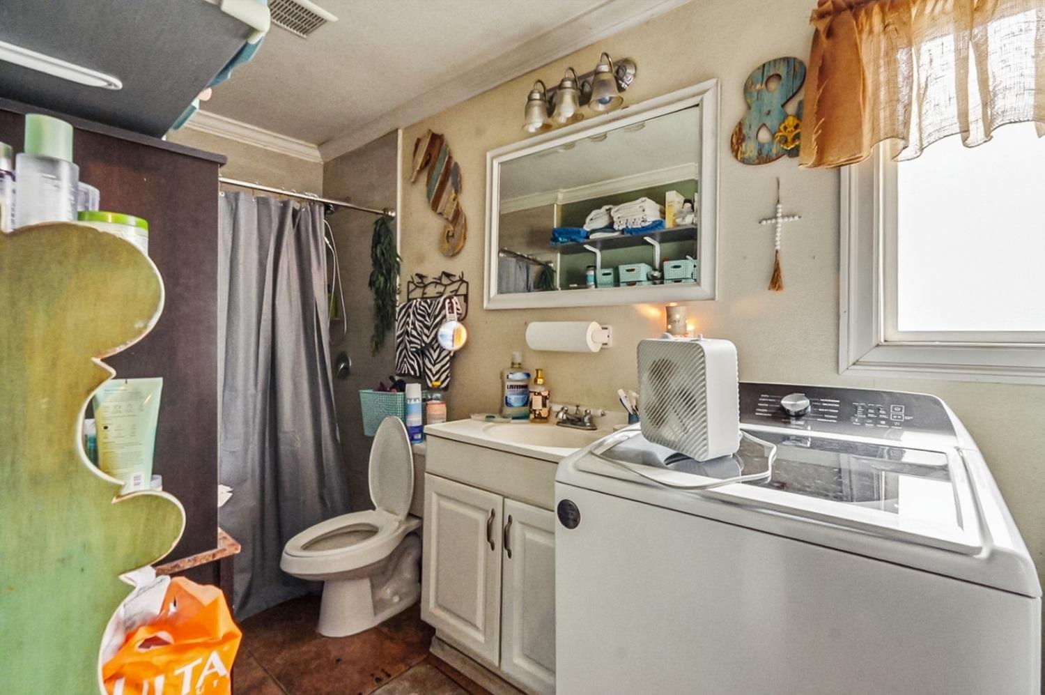 1829 River Road Modesto, CA 95351 - Photo 37 of 44 a bathroom with a sink toilet and mirror