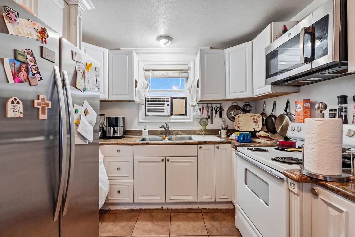 1829 River Road Modesto, CA 95351 - Photo 41 of 44 a kitchen with stainless steel appliances granite countertop a stove a sink and cabinets