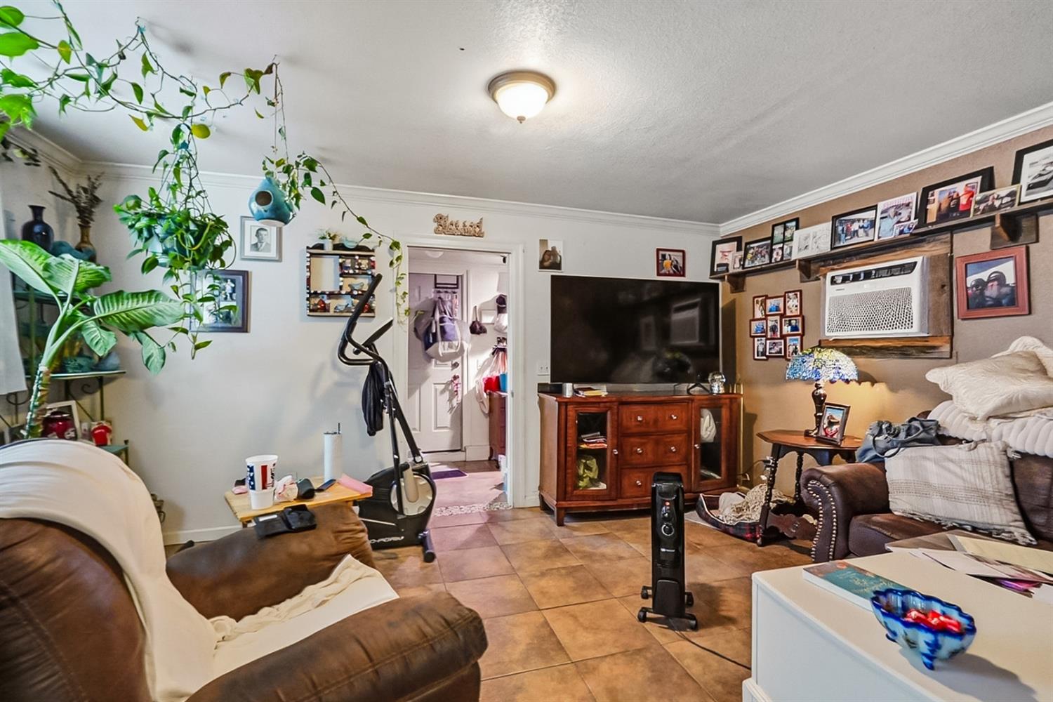 1829 River Road Modesto, CA 95351 - Photo 43 of 44 a living room with furniture gym equipment and a flat screen tv