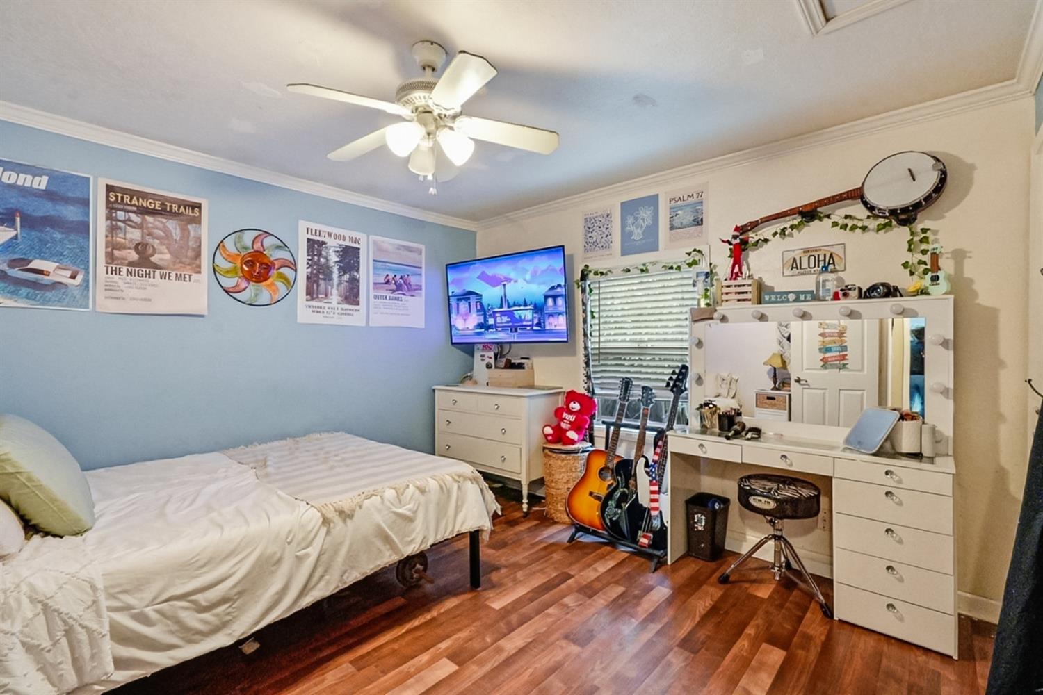 1829 River Road Modesto, CA 95351 - Photo 6 of 44 a bedroom with a bed and a chandelier