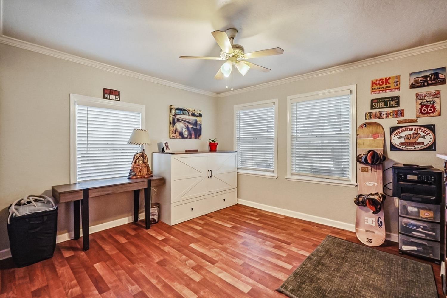 1829 River Road Modesto, CA 95351 - Photo 7 of 44 a bedroom with a bed and a chandelier
