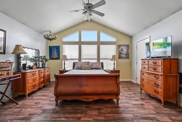 a large bedroom with a bed and furniture