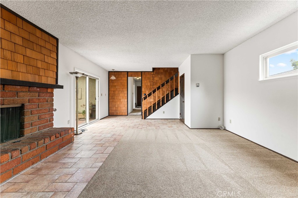 9063 Gotham Street Downey, CA 90241 - Photo 21 of 45 a view of an empty room with a fireplace