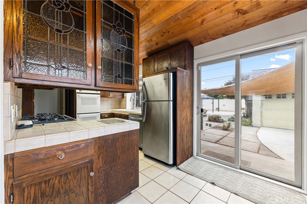 9063 Gotham Street Downey, CA 90241 - Photo 22 of 45 a kitchen with a refrigerator and a sink