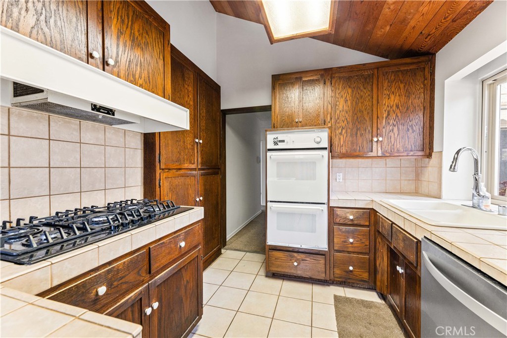 9063 Gotham Street Downey, CA 90241 - Photo 23 of 45 a kitchen with a stove and a refrigerator