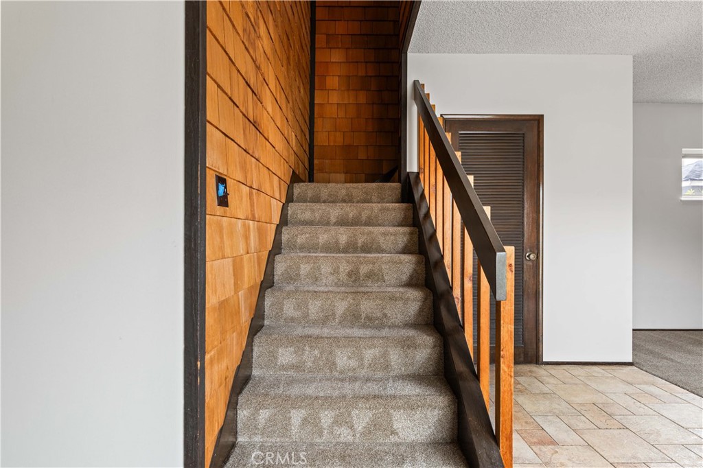 9063 Gotham Street Downey, CA 90241 - Photo 27 of 45 a view of staircase with wooden floor and a metal railing