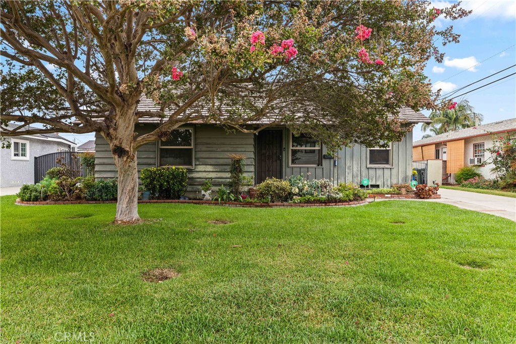 9063 Gotham Street Downey, CA 90241 - Photo 3 of 45 a front view of a house with garden