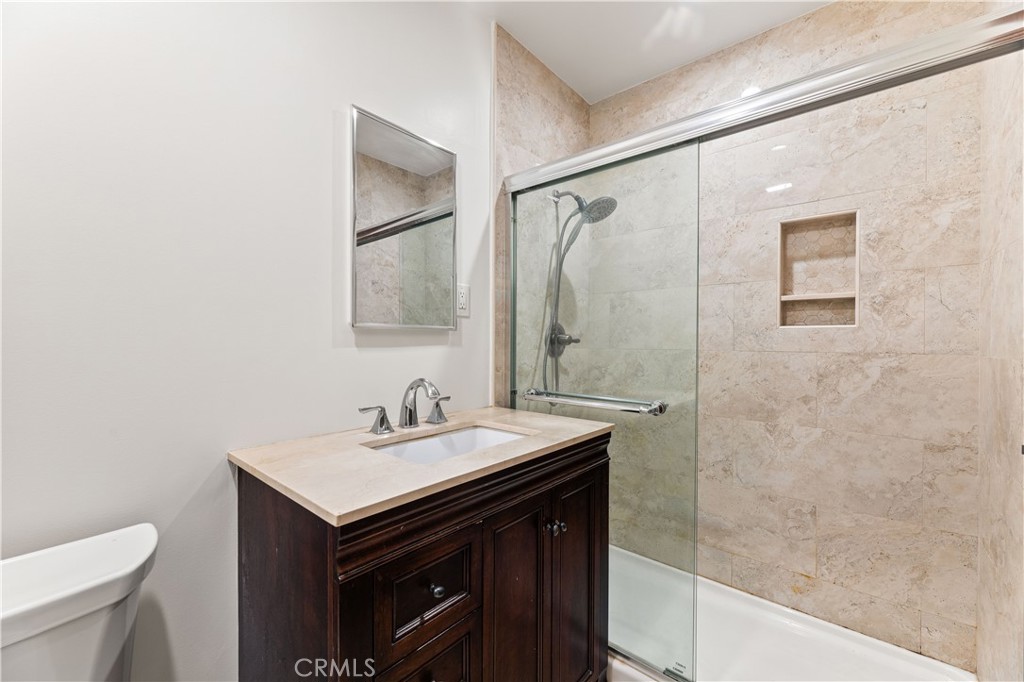 9063 Gotham Street Downey, CA 90241 - Photo 34 of 45 a bathroom with a sink a toilet and shower
