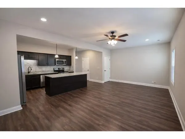a view of kitchen with sink microwave and refrigerator