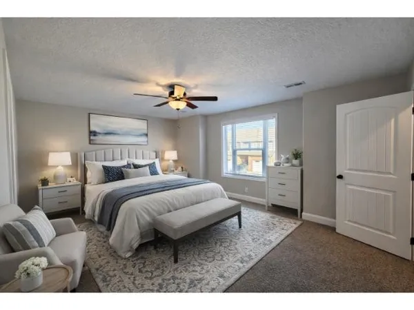 a bedroom with a bed and a chandelier