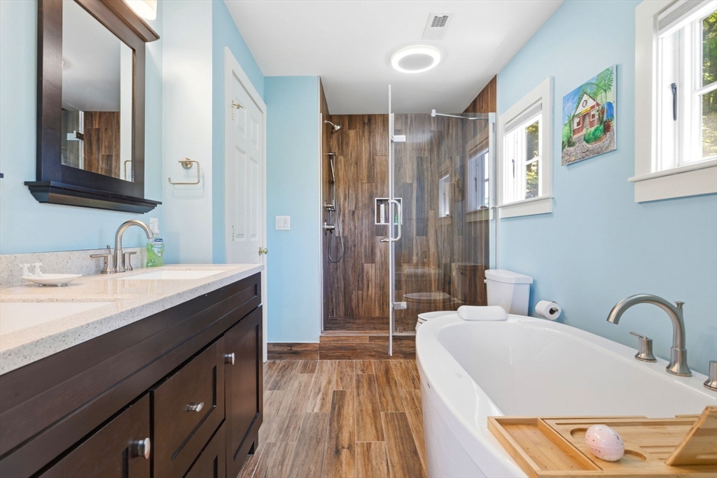 35 Keyes Road Westford, MA 01886 - Photo 23 of 40 a spacious bathroom with a double vanity sink a mirror and a shower