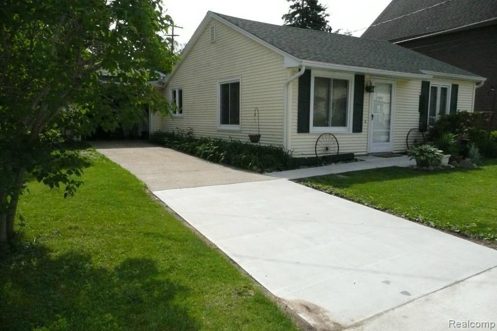 110 North Maple Street Fowlerville, MI 48836 - Photo 2 of 17 New cement drive and walk.