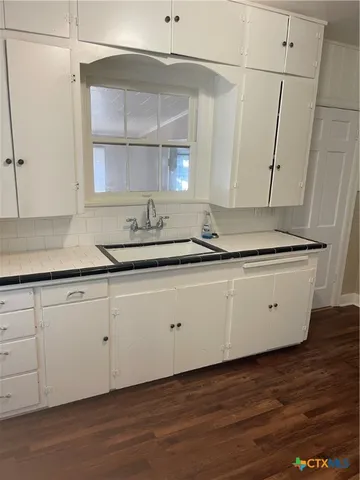 a kitchen with a sink and cabinets