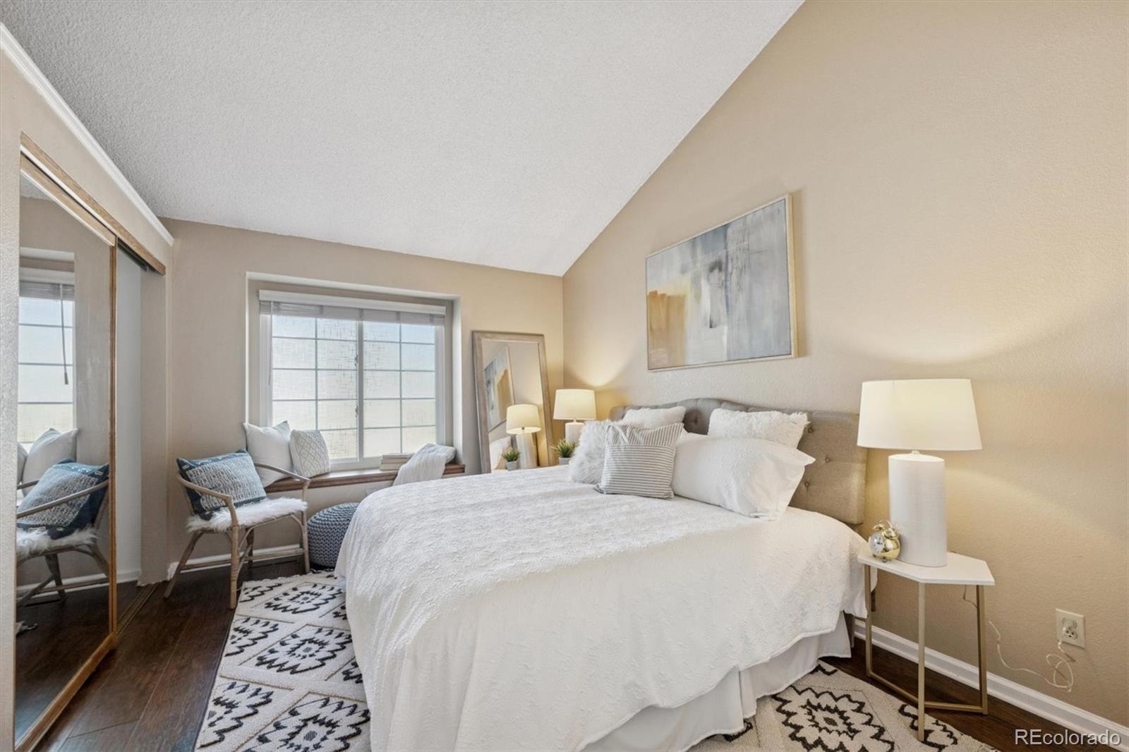 2002 South Xenia Way Denver, CO 80231 - Photo 13 of 23 a bedroom with a bed and wooden floor
