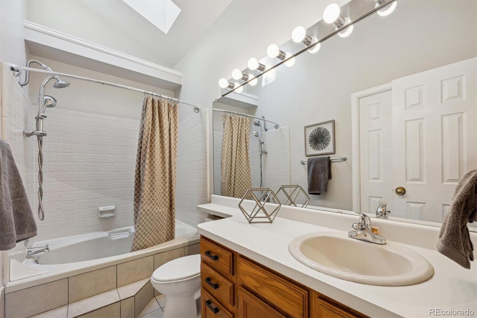 2002 South Xenia Way Denver, CO 80231 - Photo 14 of 23 a bathroom with a sink double vanity granite tub and a mirror