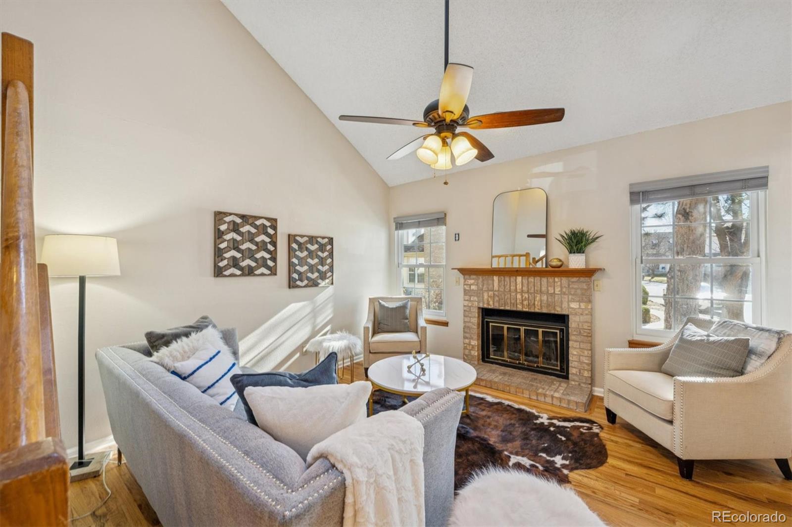 2002 South Xenia Way Denver, CO 80231 - Photo 3 of 23 a living room with furniture a fireplace and a chandelier