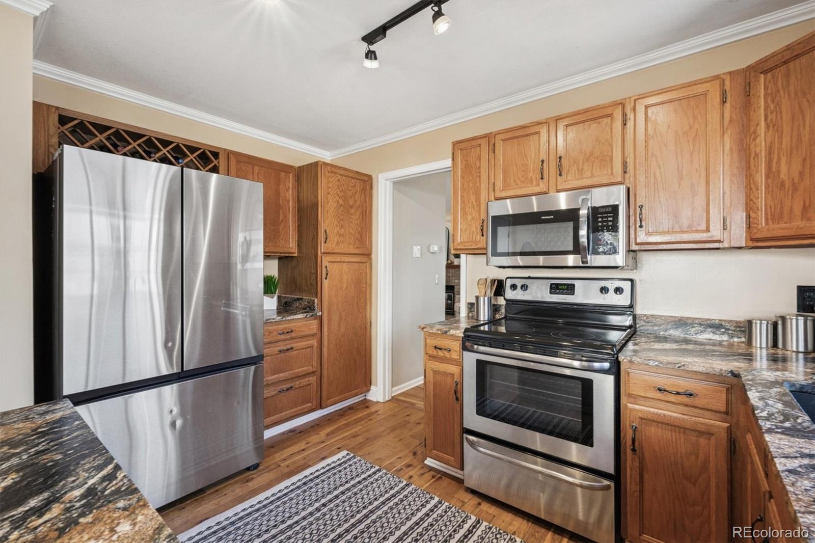 2002 South Xenia Way Denver, CO 80231 - Photo 10 of 23 a kitchen with a refrigerator stove and microwave