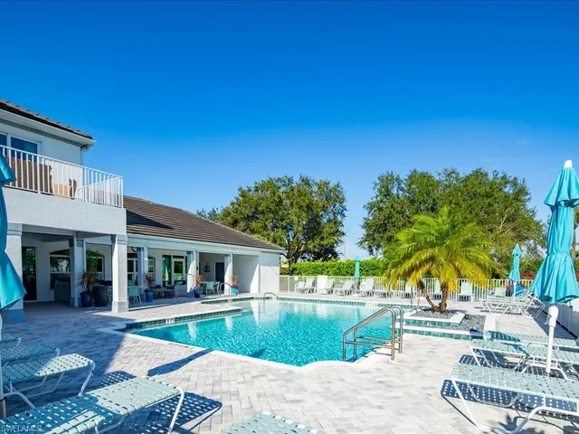 a view of house with outdoor space and swimming pool