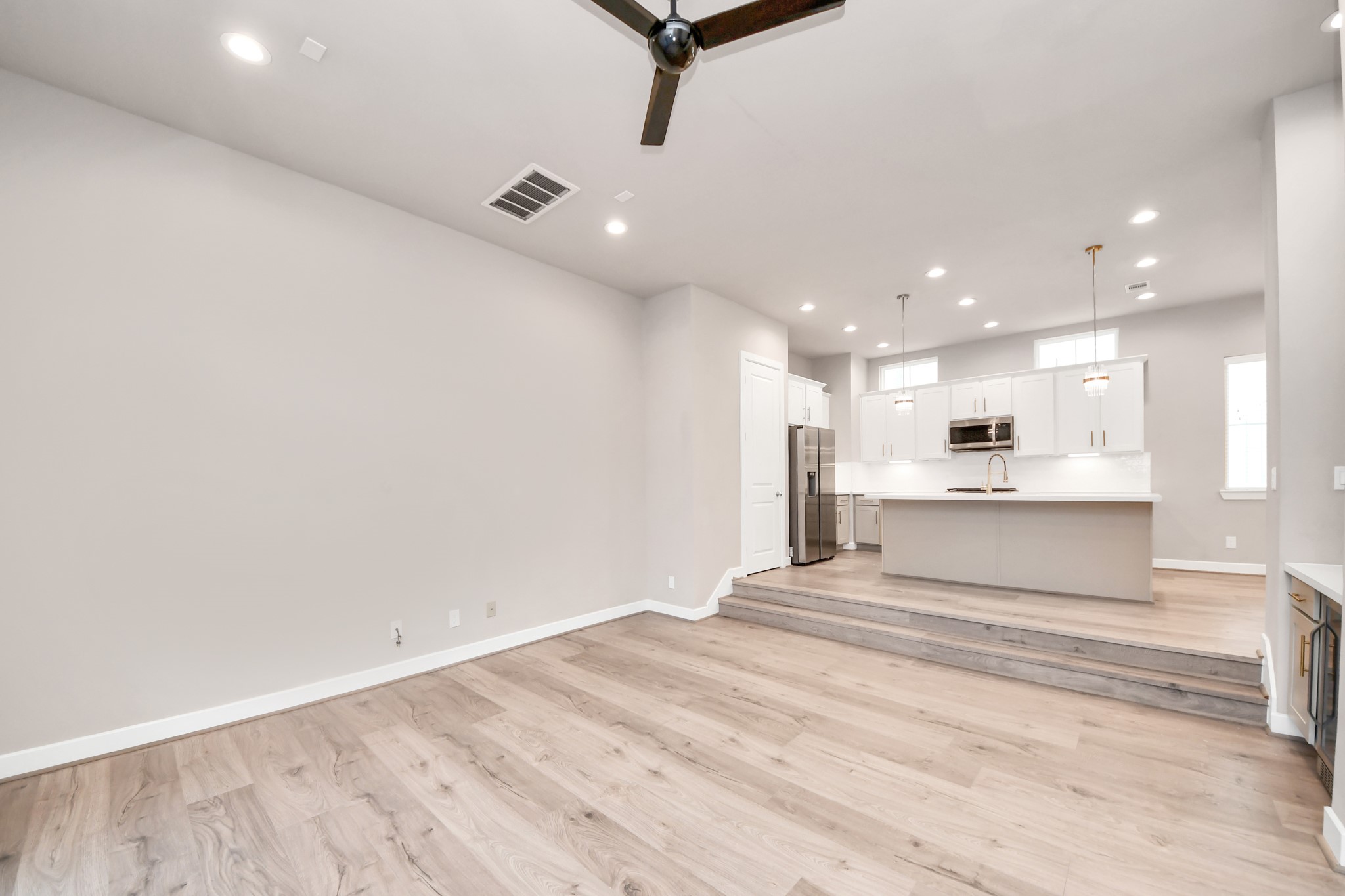 2114 Stuart Street Houston, TX 77004 - Photo 23 of 39 a view of a kitchen with kitchen island a sink stainless steel appliances and cabinets