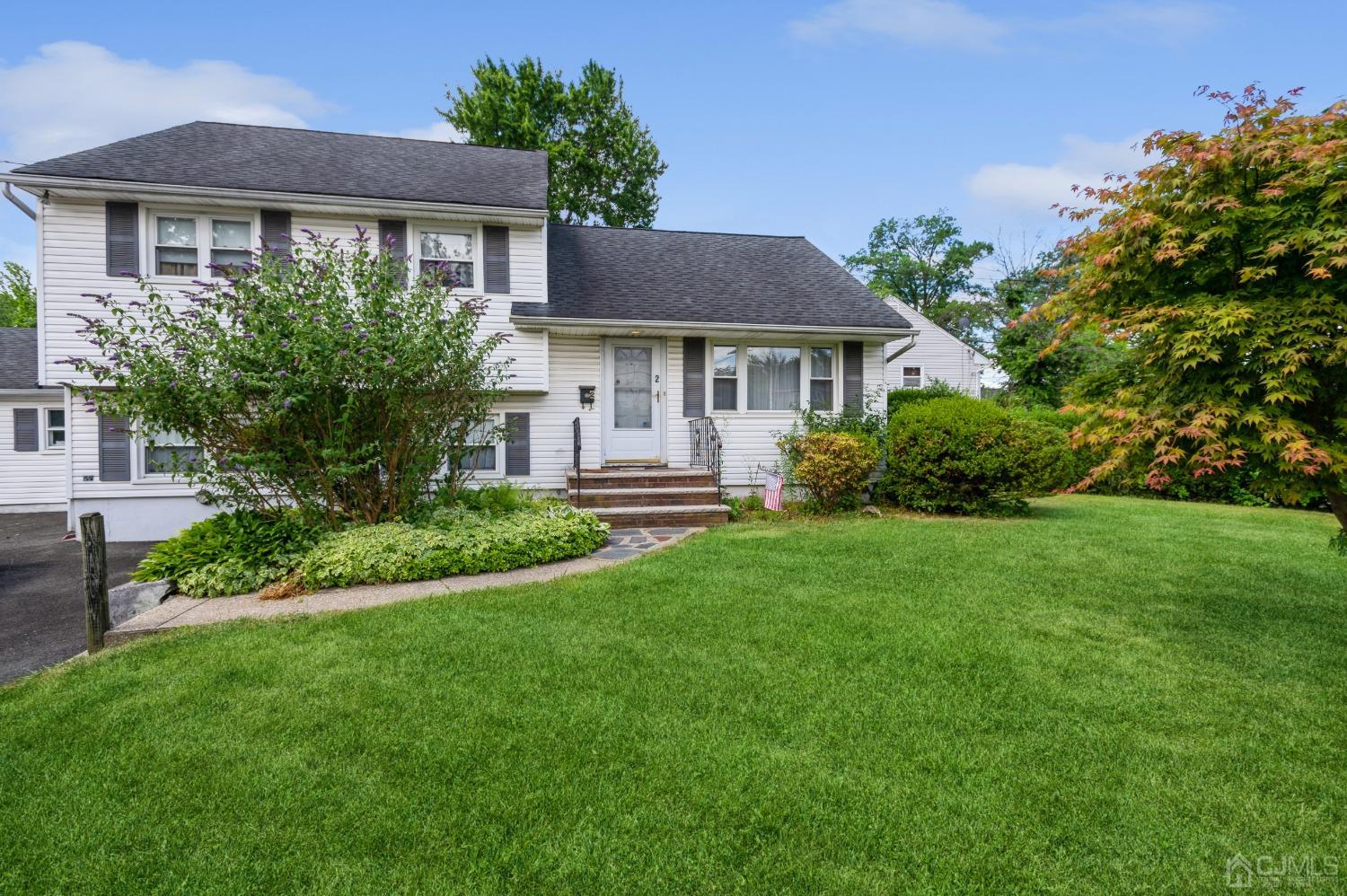 2 Leland Road Edison, NJ 08817 - Photo 1 of 25 a front view of a house with a yard and trees