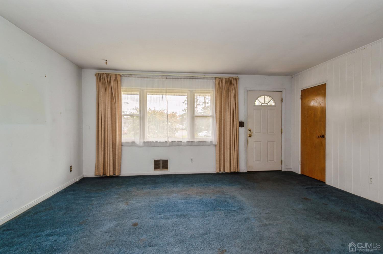 2 Leland Road Edison, NJ 08817 - Photo 4 of 25 an empty room with wooden floor and windows