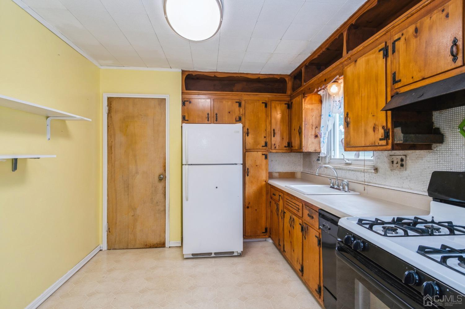2 Leland Road Edison, NJ 08817 - Photo 10 of 25 a kitchen with a refrigerator a stove top oven a sink and dishwasher