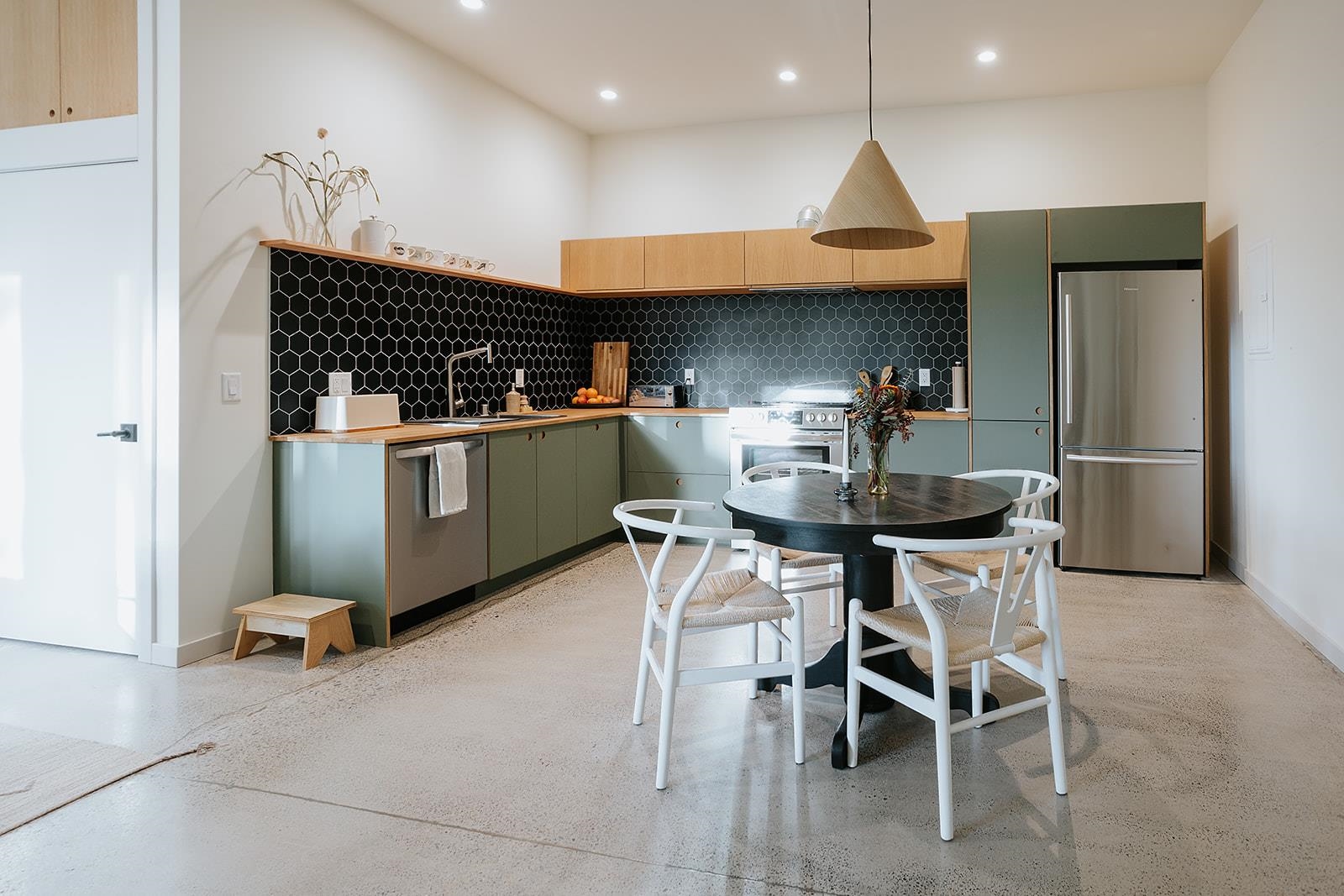 14802 Foxboro Drive Truckee, CA 96161 - Photo 20 of 21 a kitchen with stainless steel appliances kitchen island granite countertop a table and chairs in it