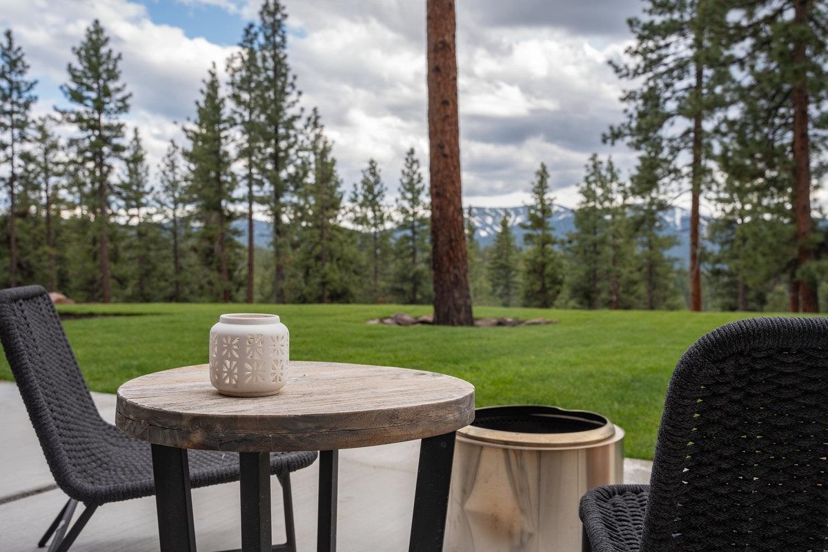14802 Foxboro Drive Truckee, CA 96161 - Photo 3 of 21 a view of a patio with a table chairs and a fire pit
