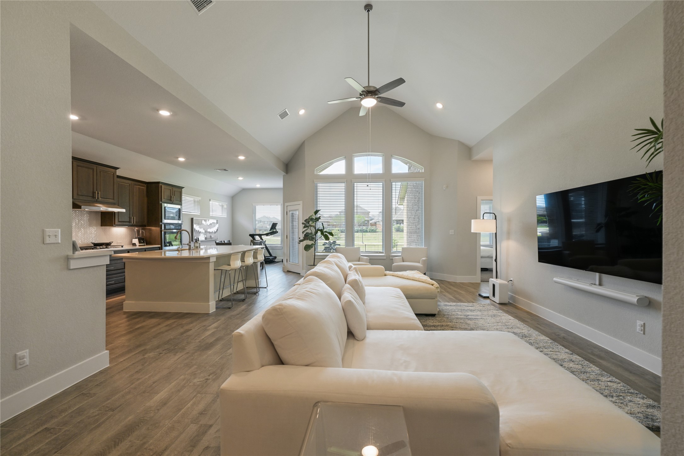 238 Wild Pecan Loop Buda, TX 78610 - Photo 5 of 31 Soaring vaulted ceilings and rich wood floors anchor this expansive open-concept living area.