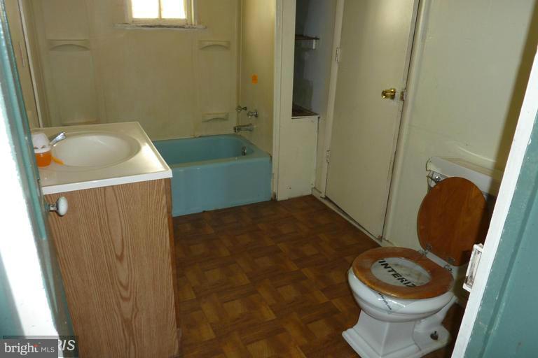 2248 Elliott Island Road Vienna, MD 21869 - Photo 4 of 10 a bathroom with a sink a toilet and shower
