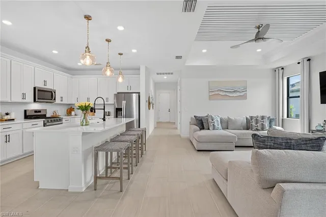 a large white kitchen with granite countertop lots of counter top space