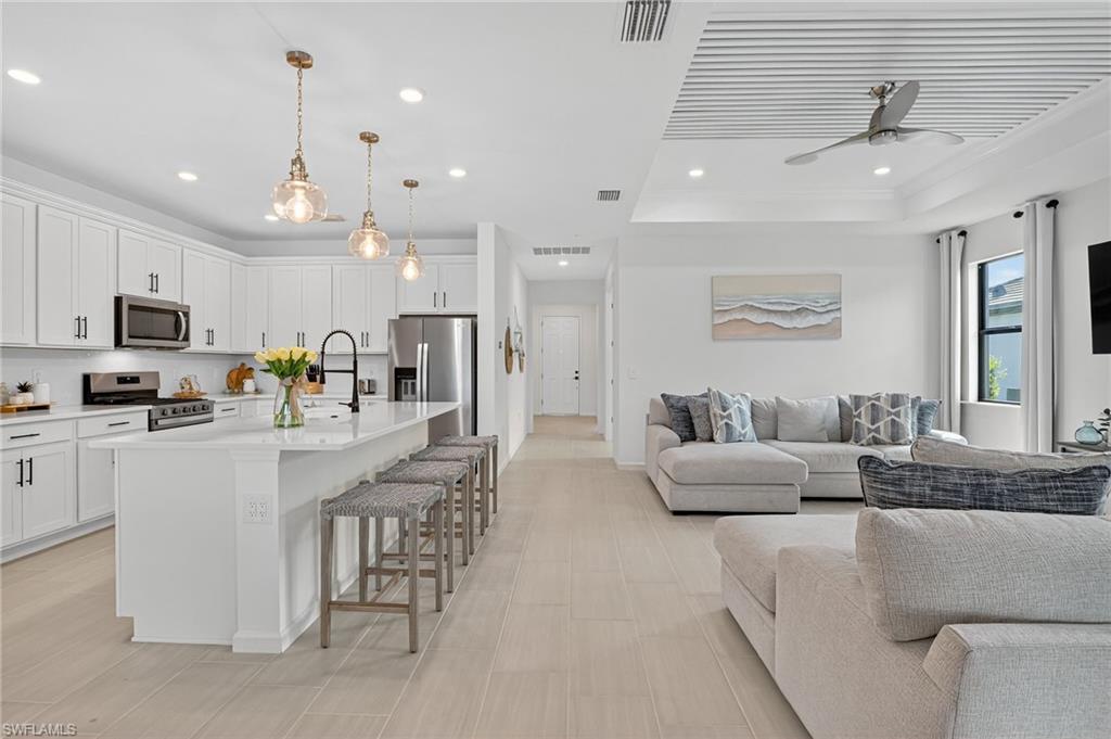 1953 Fresno Avenue Naples, FL 34120 - Photo 14 of 33 a large white kitchen with granite countertop lots of counter top space